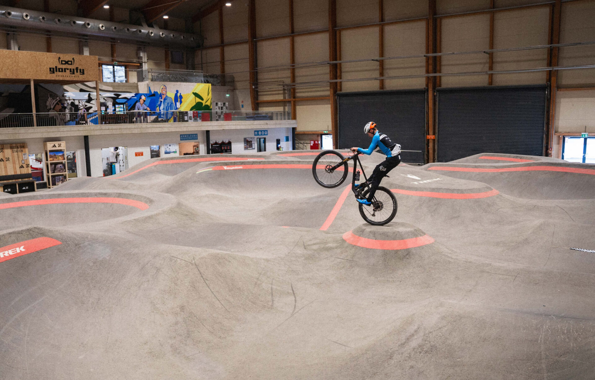 Mountain biker jumps over an elevation in the AREA 47 indoor bike park in Ötztal, Tyrol
