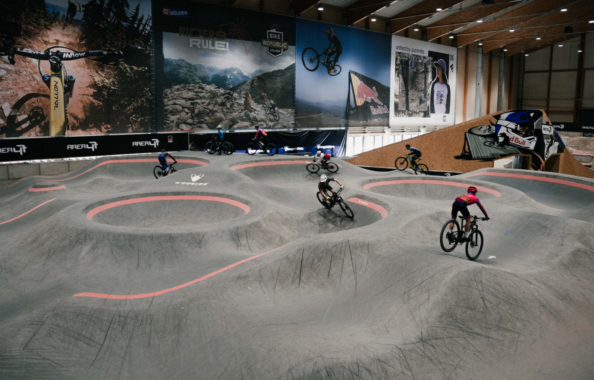 Mountain bikers on a bend in the indoor bike park at AREA 47 in Ötztal, Tyrol