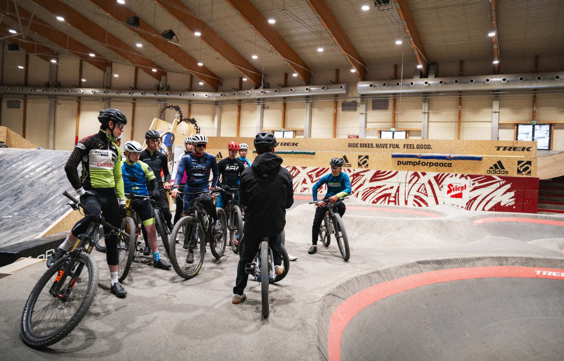 Group of young mountain bikers taking a break in the AREA 47 indoor bike park in Ötztal, Tyrol