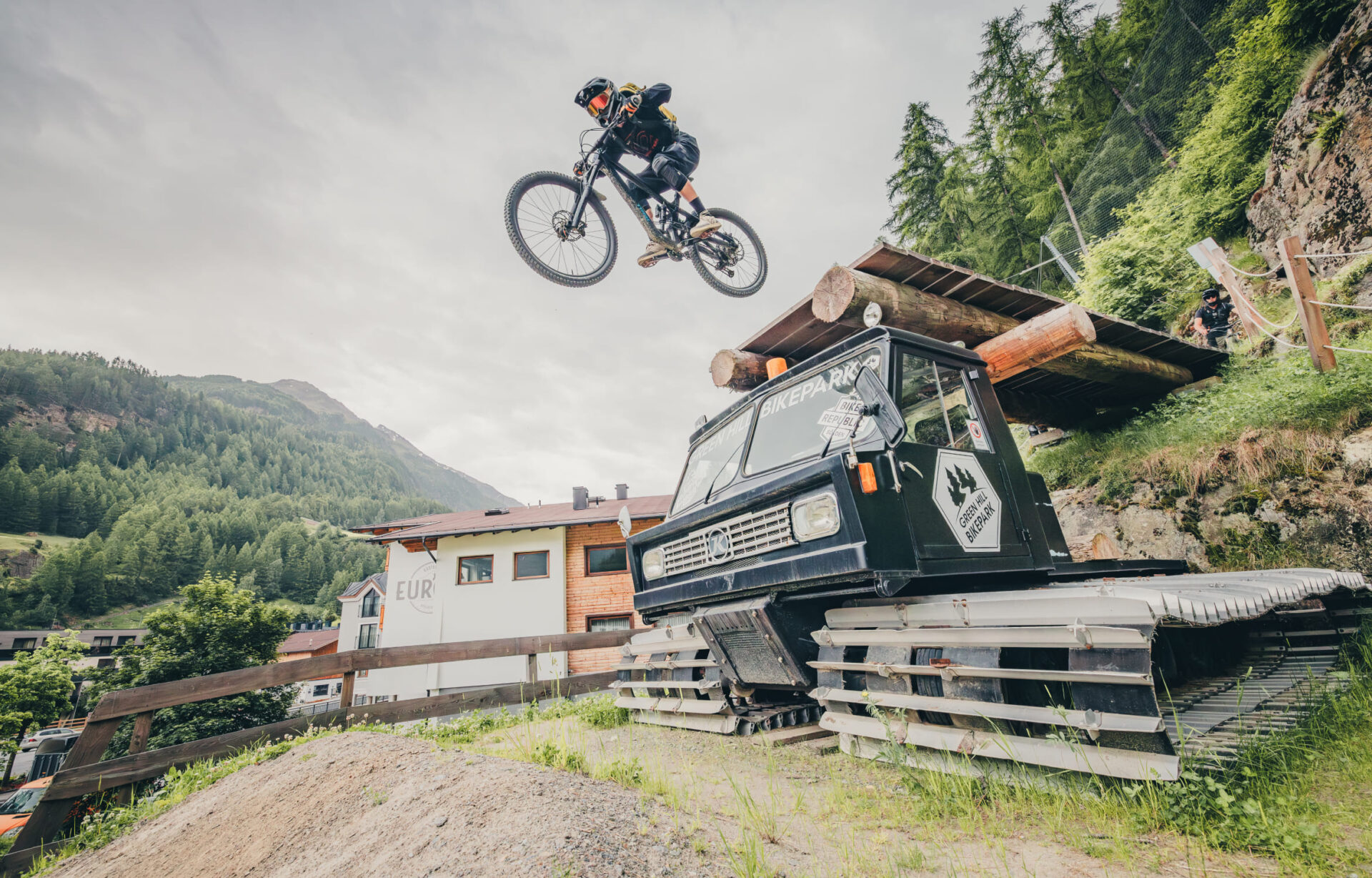 Mountain biker jumps off a platform with his bike at AREA 47 in Ötztal, Tyrol