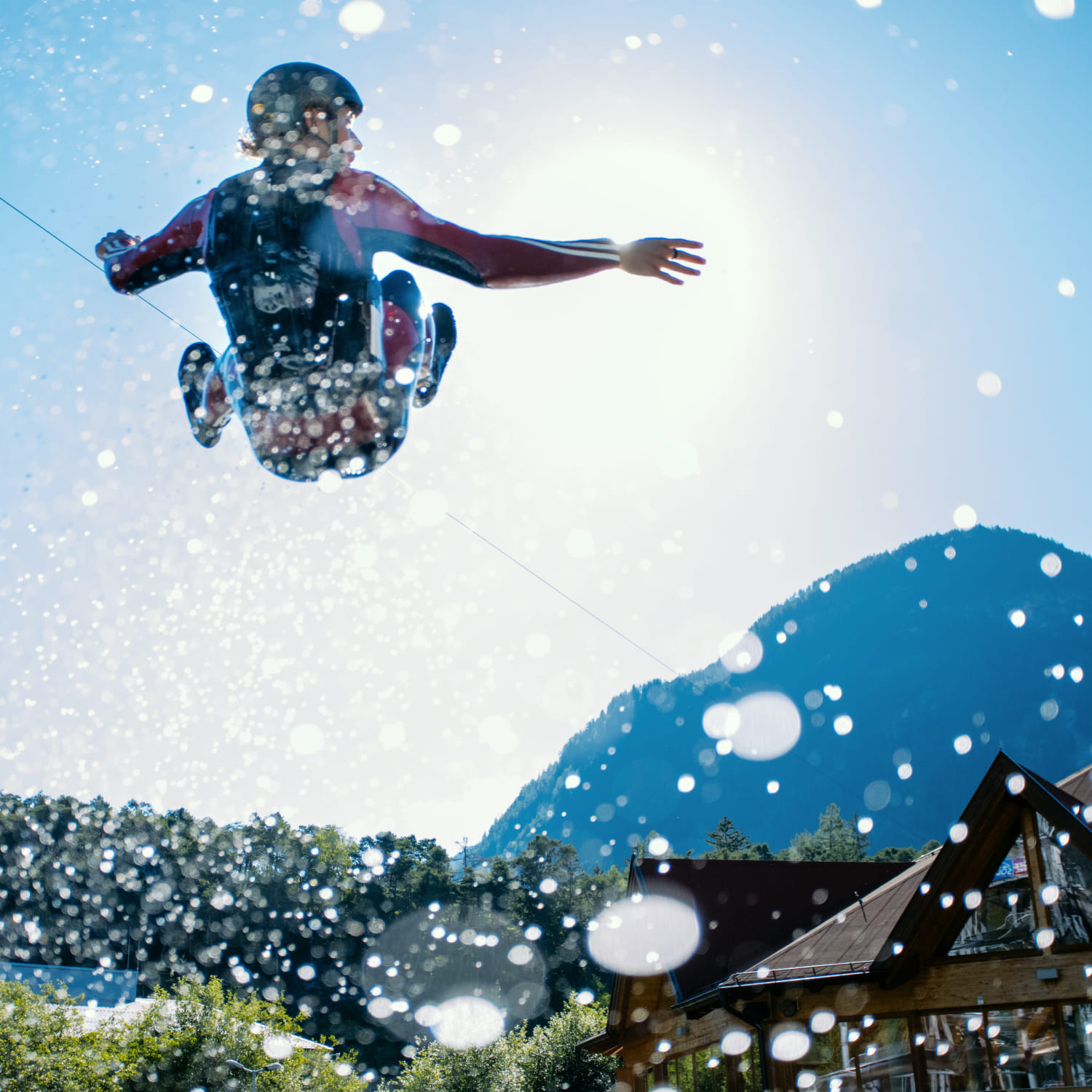Participants in the air after a jump from the blobbing catapult at AREA 47, Ötztal, Tyrol