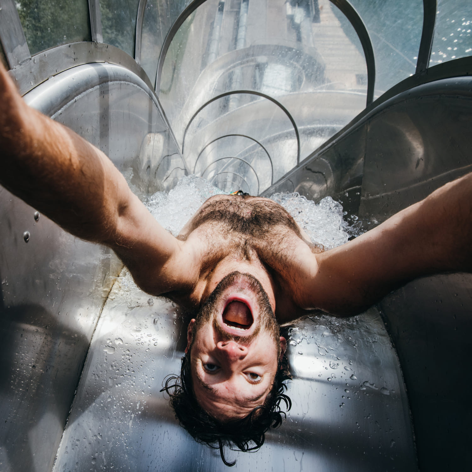 Man takes a selfie while sliding through a closed water slide at AREA 47 in Ötztal, Tyrol