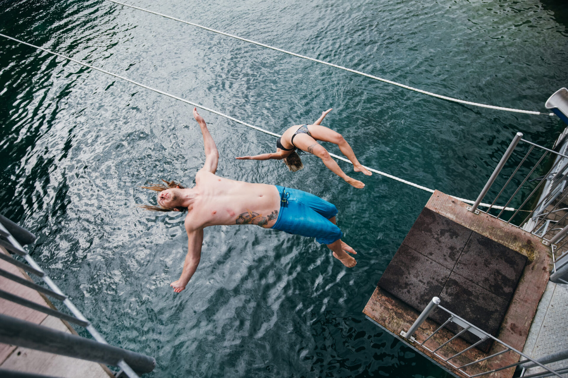 Two visitors to AREA 47 in Ötztal, Tyrol, jump from a diving platform