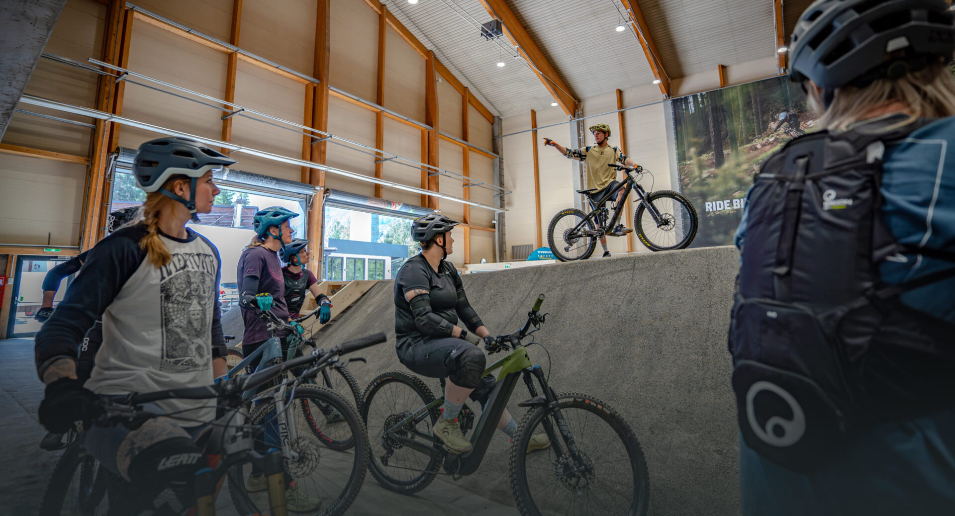 Group of mountain bikers taking a break in the AREA 47 indoor bike park in Ötztal, Tyrol