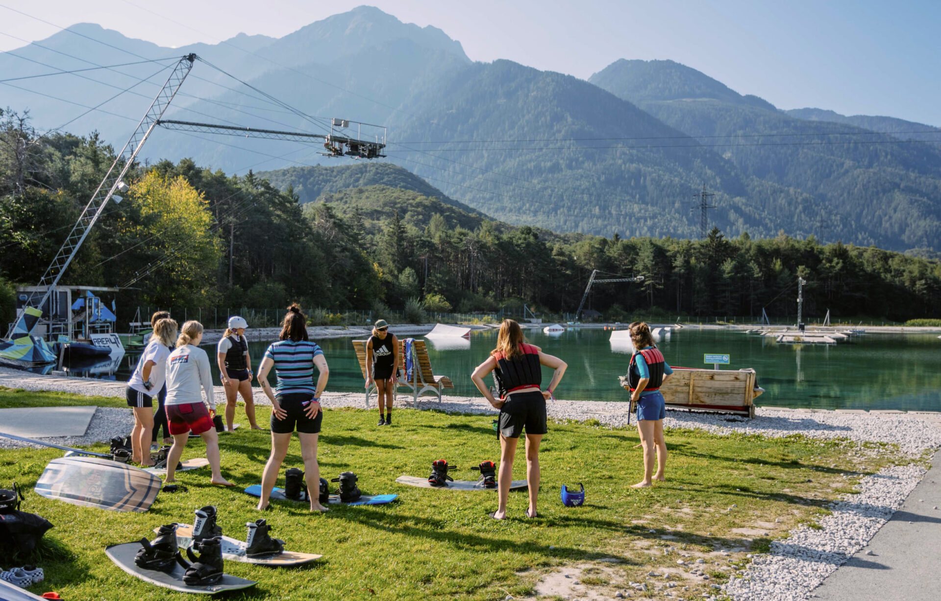 Outdoor wakeboarding class at AREA 47, Ötztal, Tyrol, with a group practicing on the grass near the lake