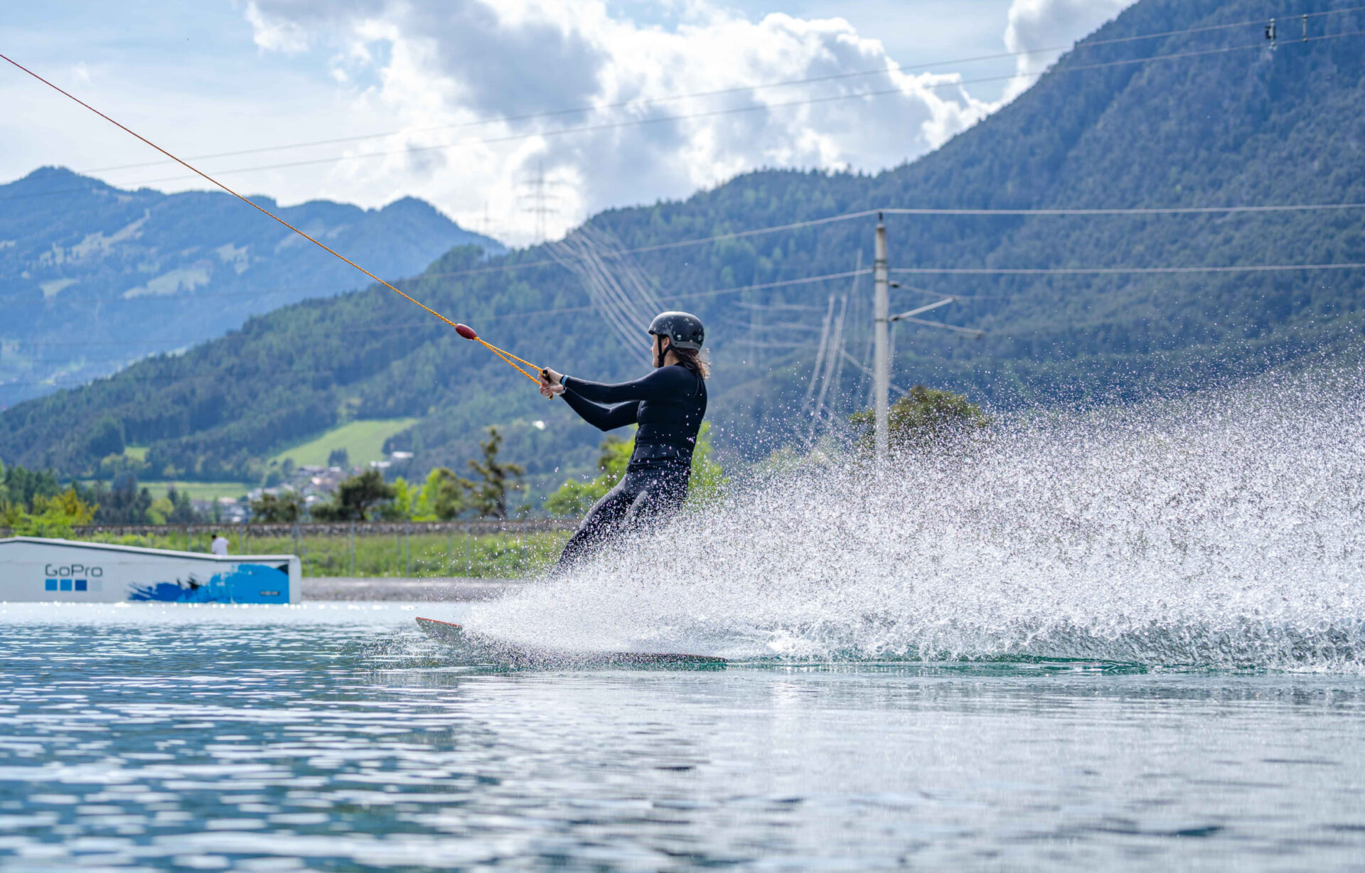 Wakeboarder creating a splash while riding at AREA 47, Ötztal, Tyrol
