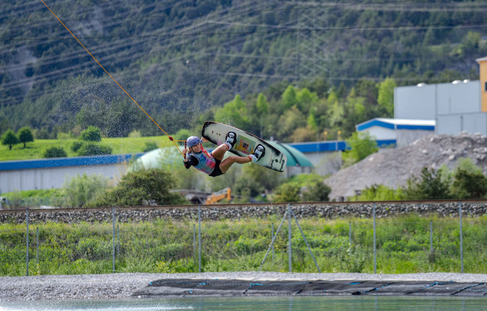 Wakeboarder performing a jump from a ramp at AREA 47, Ötztal, Tyrol