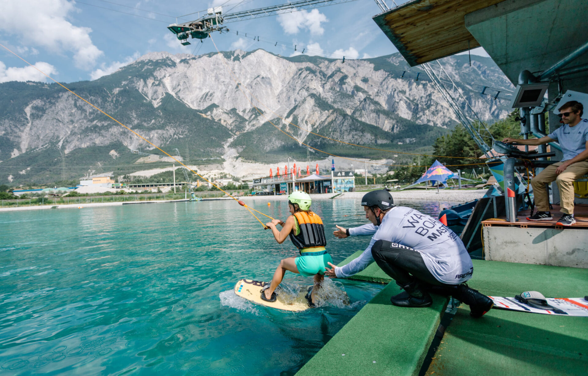 Wakeboarder preparing to start at the platform on the lake at AREA 47, Ötztal, Tyrol