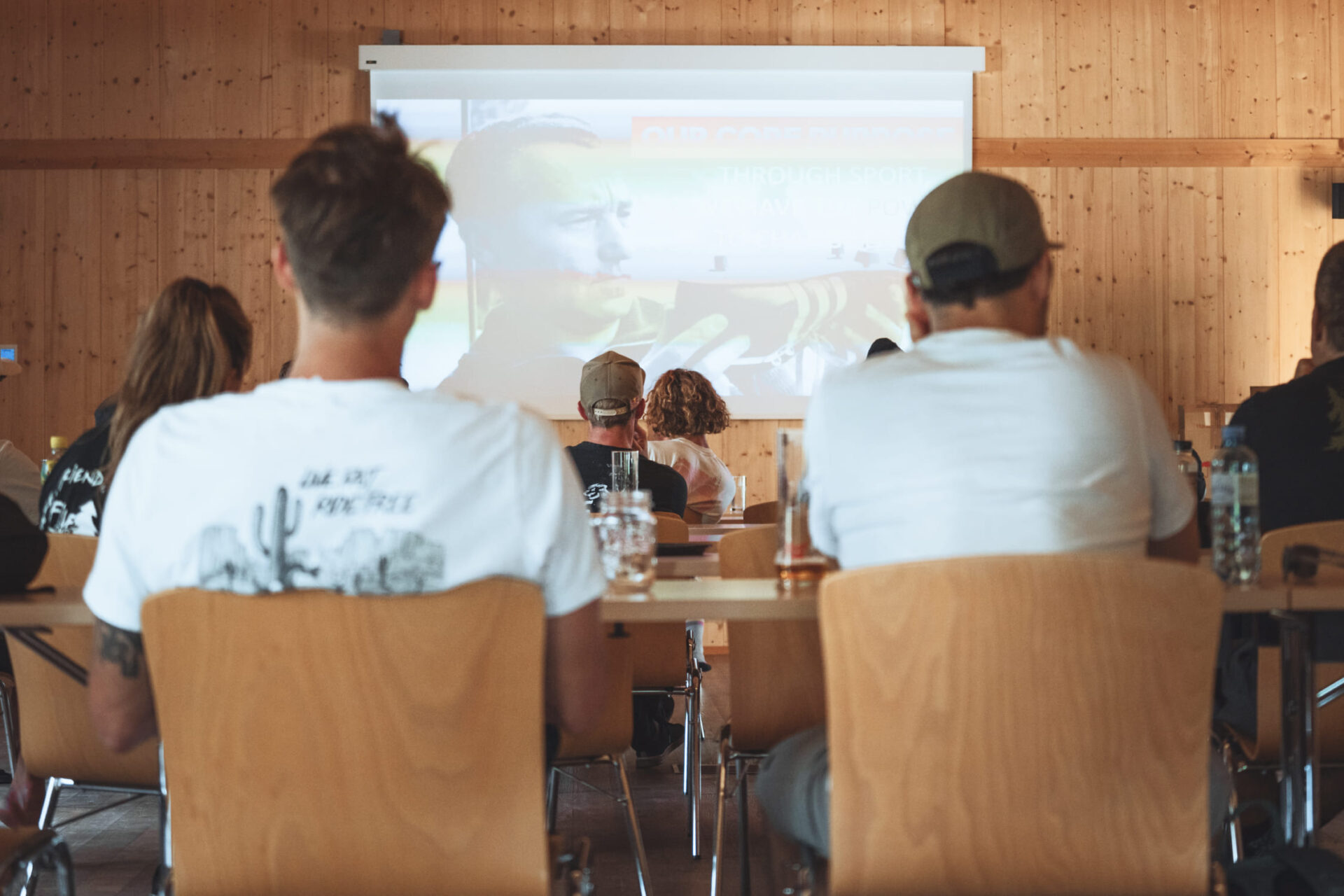 People at a presentation in the Meeting Lodge of AREA 47, Ötztal, Tyrol