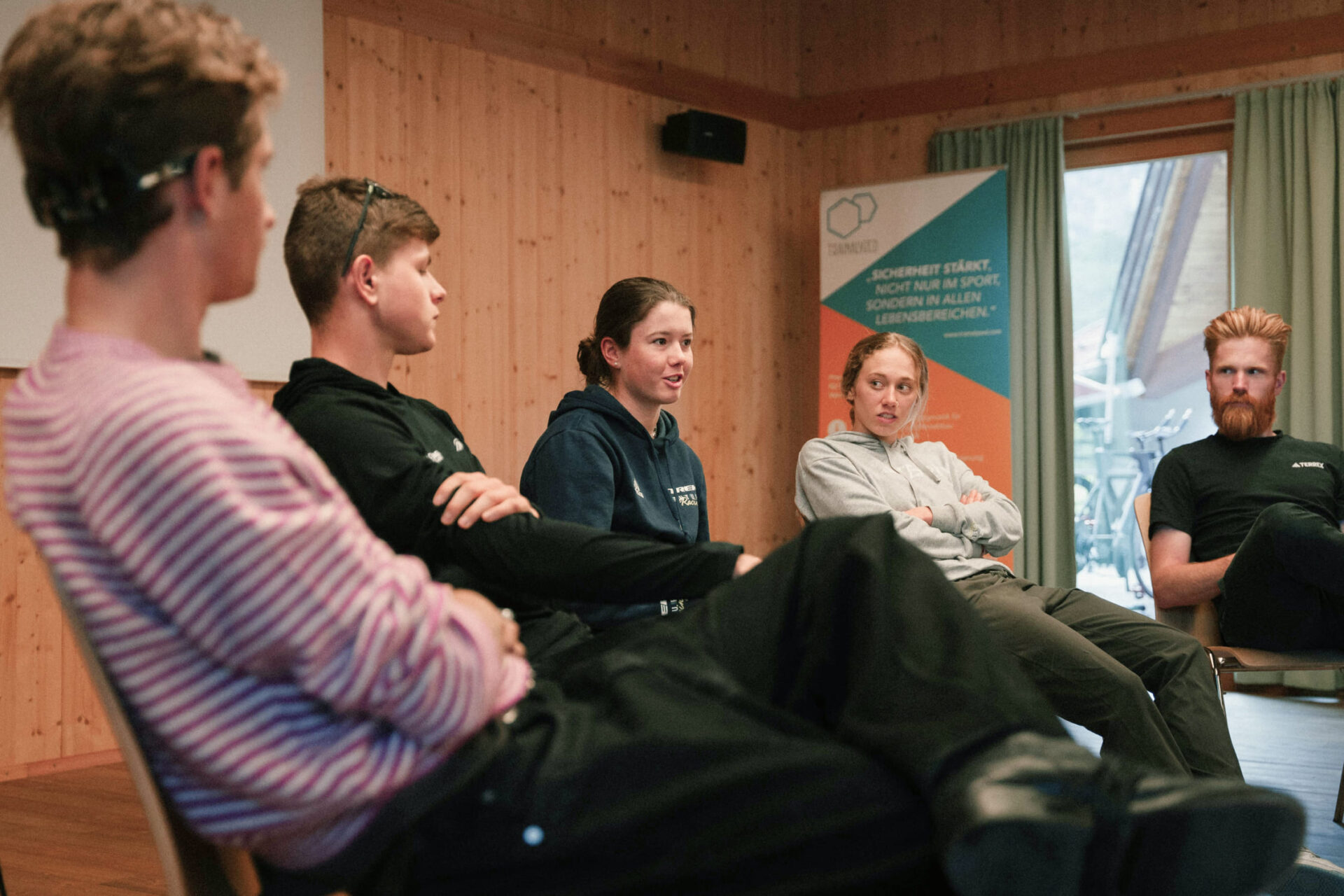 Group of people engaged in a discussion at AREA 47 in Ötztal, Tirol
