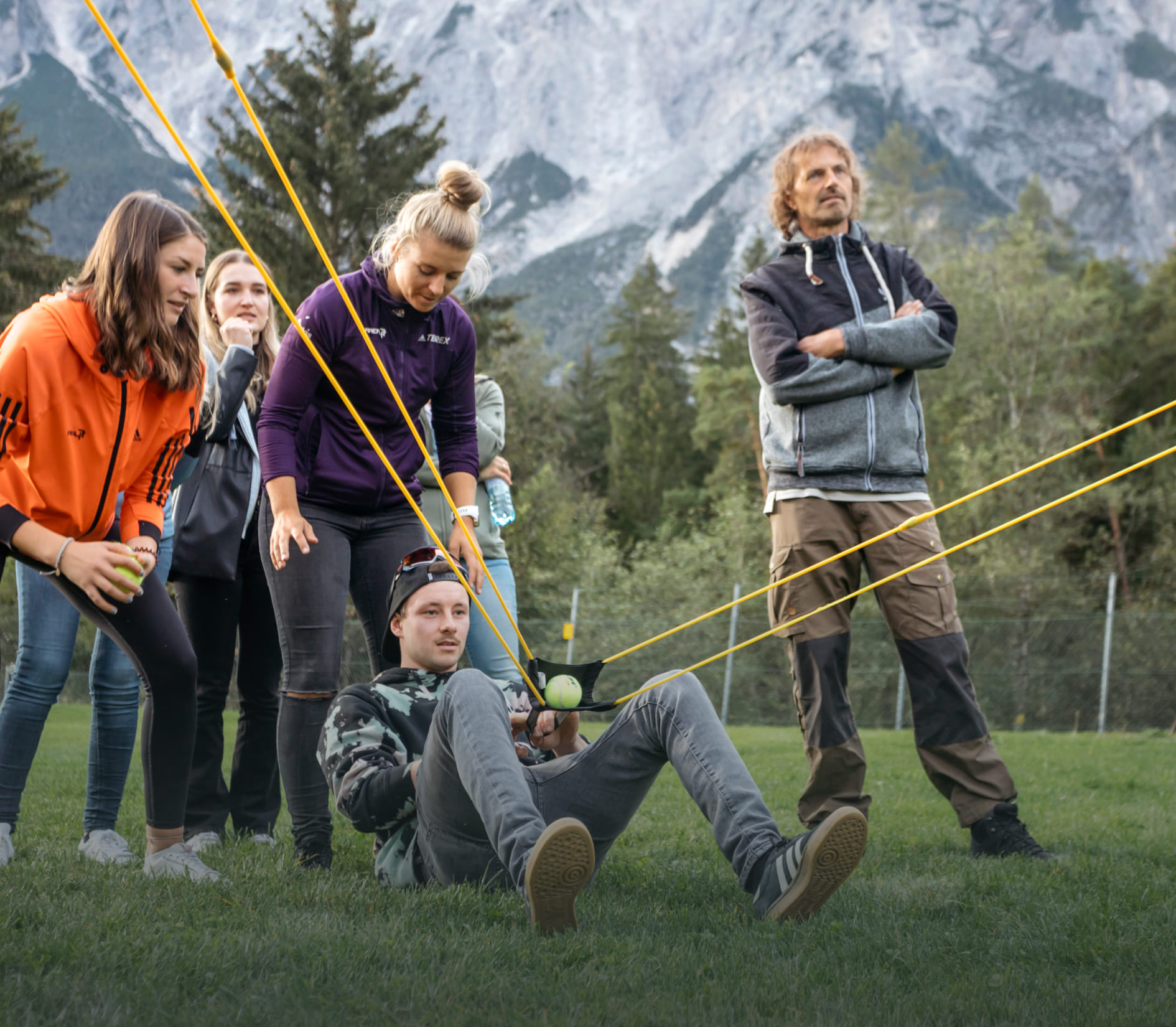 Team playing catapult game during a team building event in AREA 47, Ötztal, Tyrol