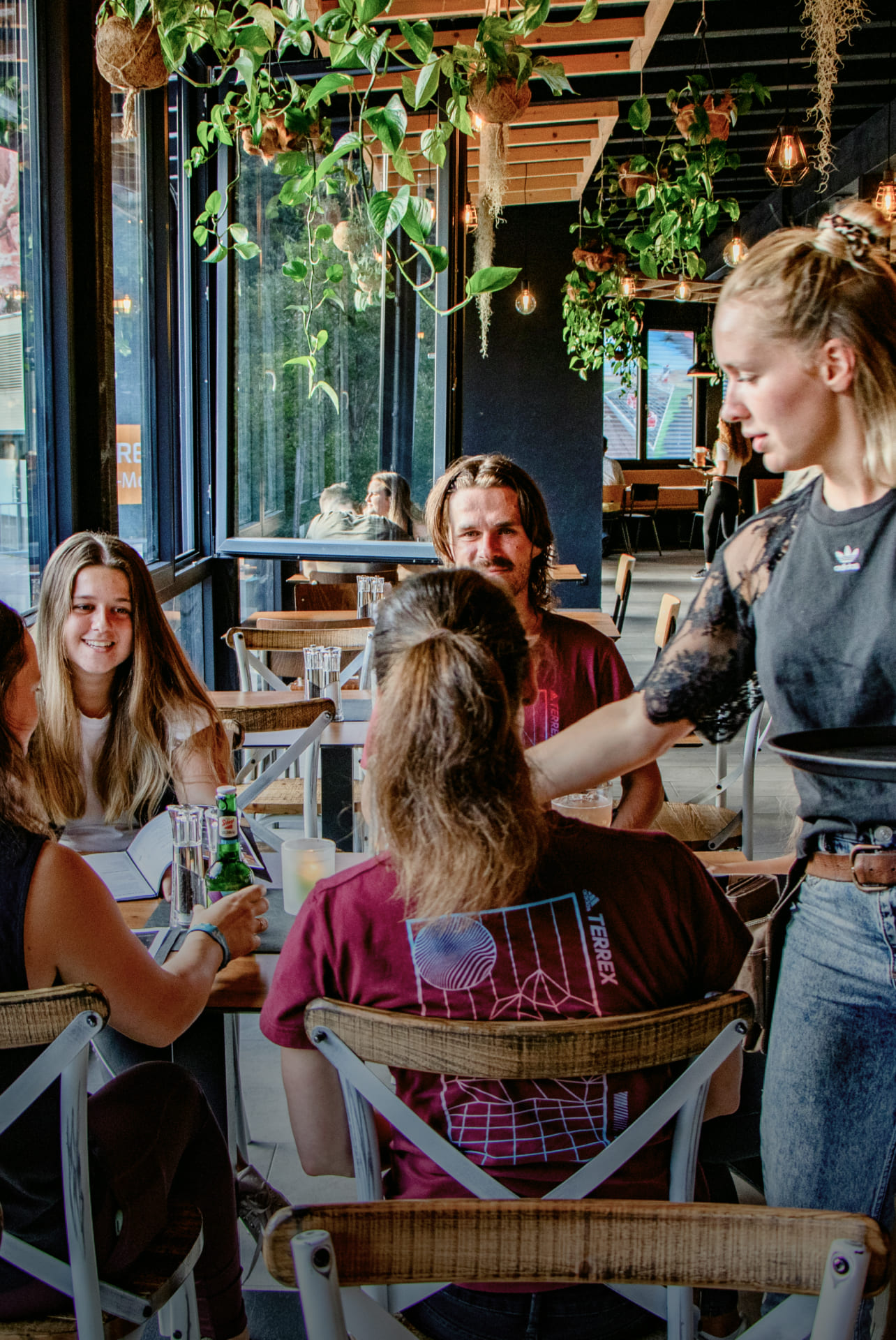 Waitress serving food in a restaurant at AREA 47, Ötztal, Tyrol